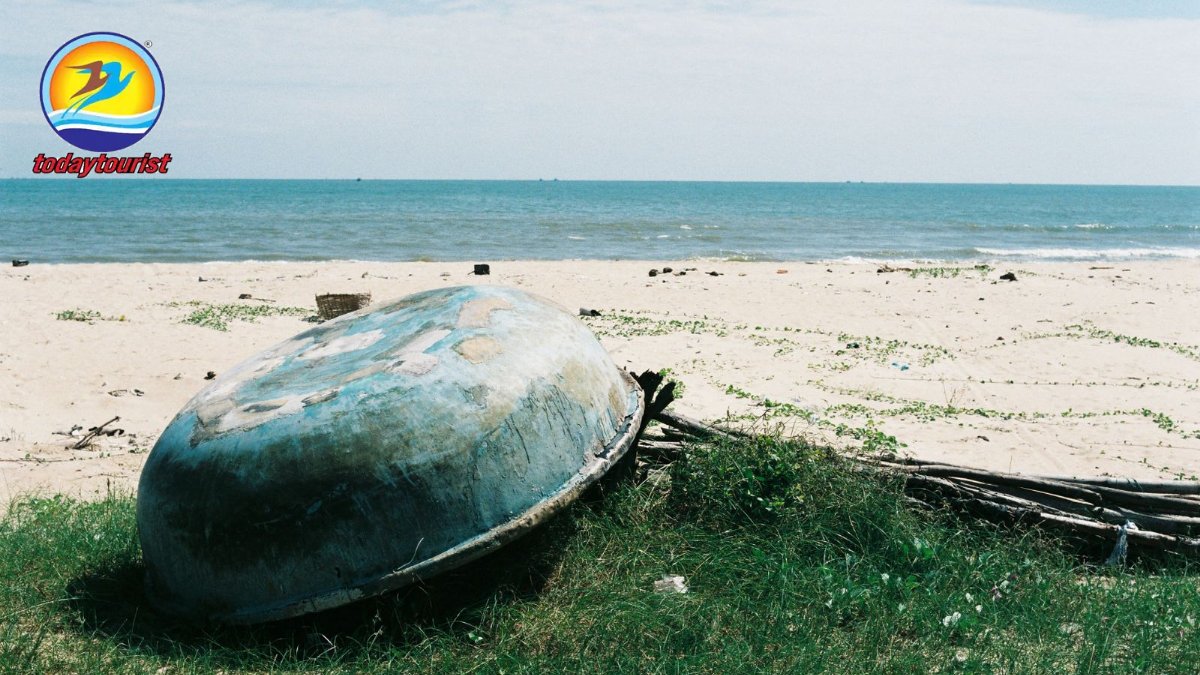Rustic beach scene with an overturned boat on Ba Ria's shore, Vietnam.