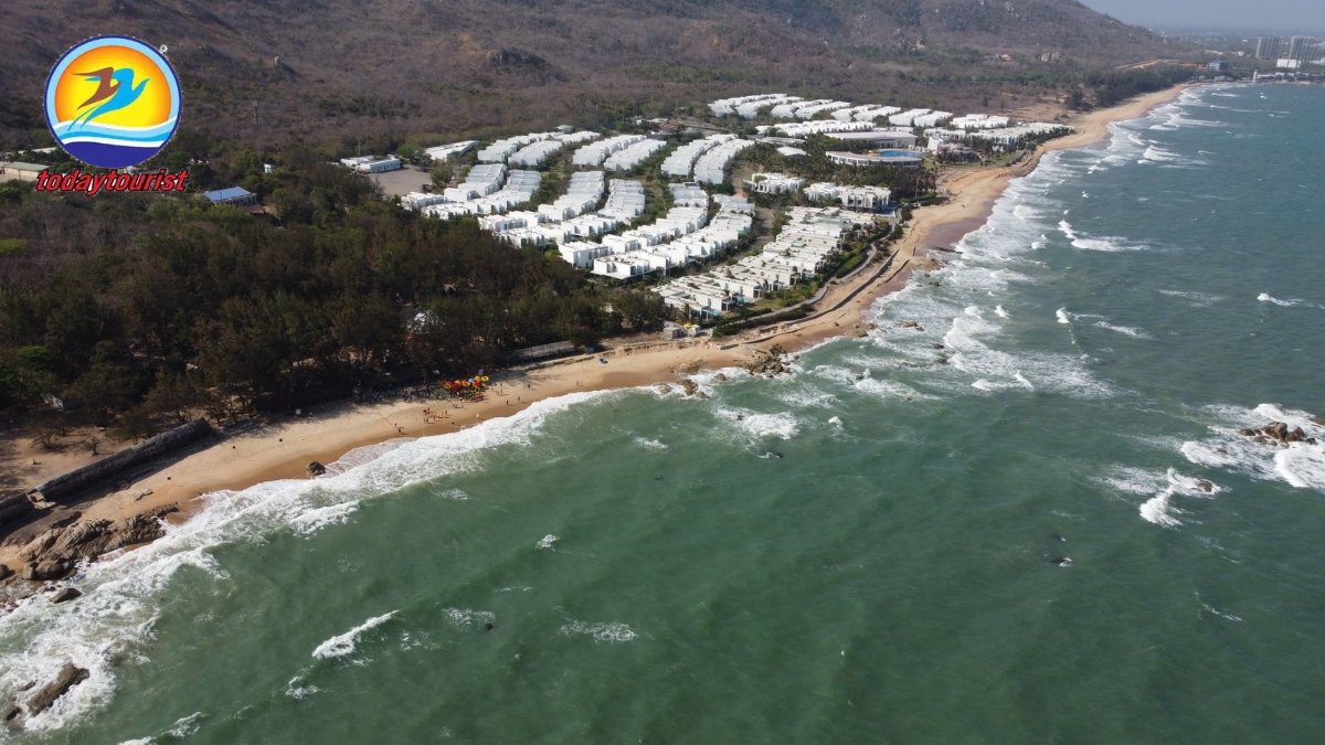 A stunning aerial shot of a luxury resort nestled along a Vietnamese b
