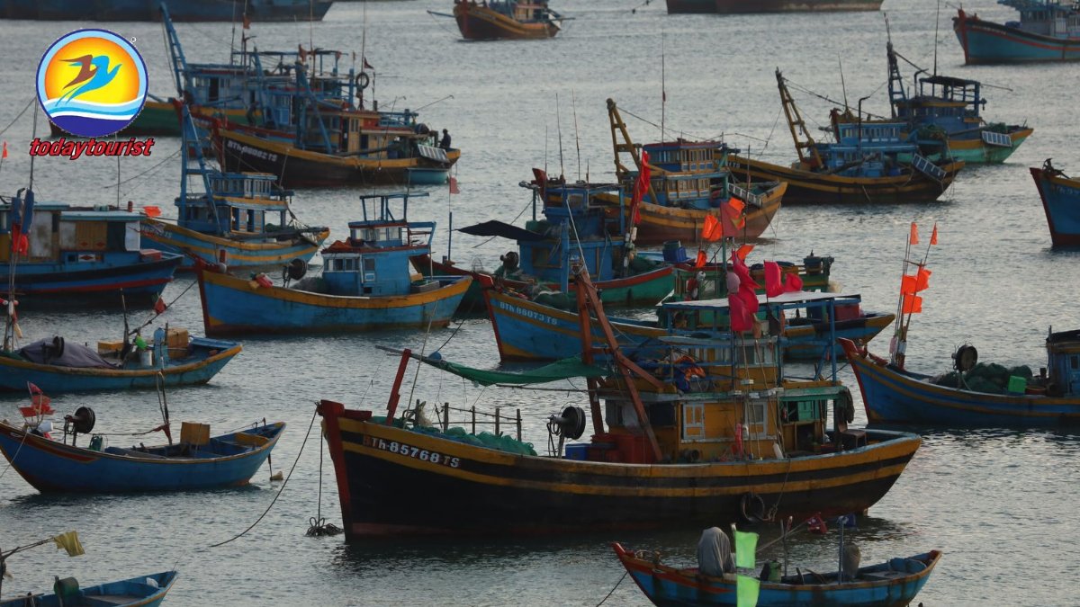 A vibrant scene of traditional fishing boats in a bustling harbor at s