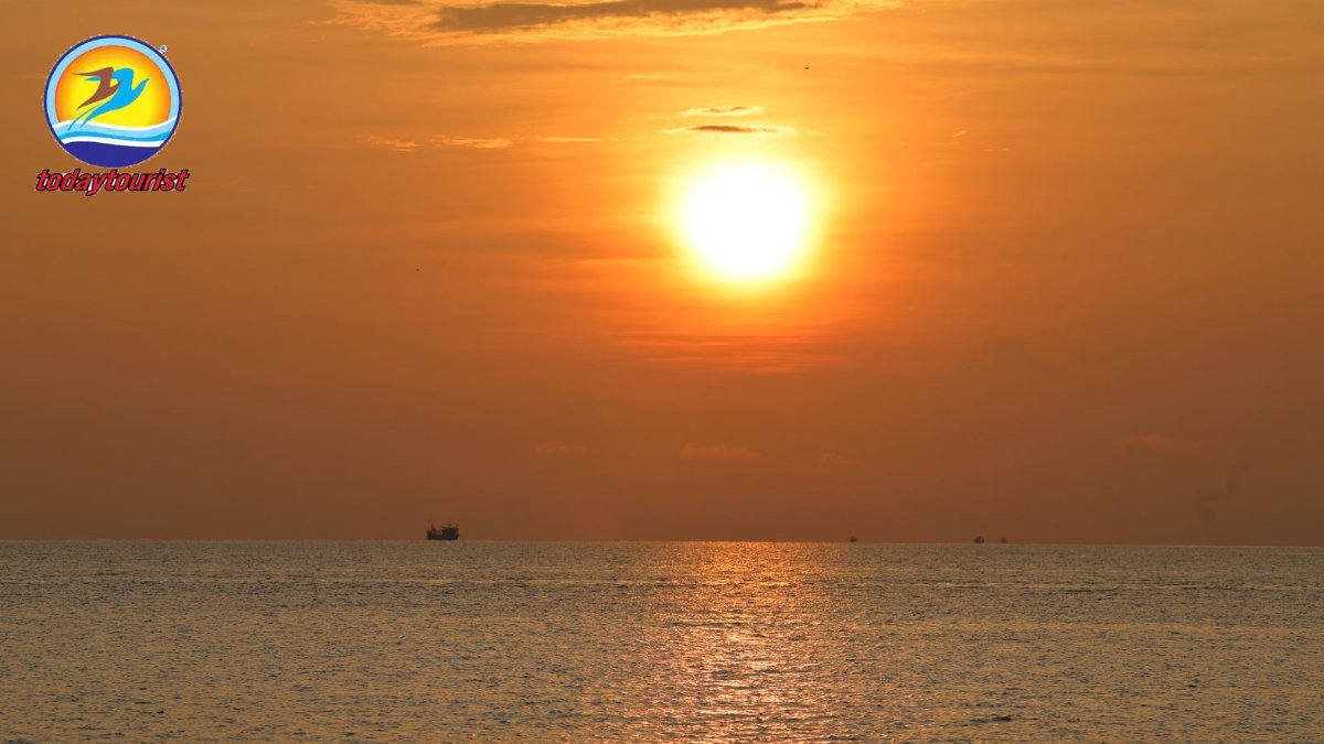 A vibrant sunset over the ocean in Vietnam, casting warm hues across t