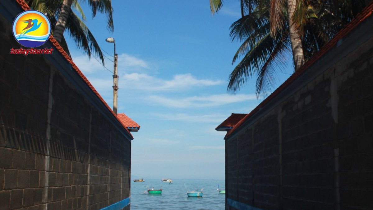 A serene seaside alley with a blue round fishing boat and palm trees, 