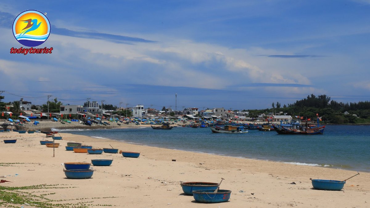 A tranquil village by the sea with fishing boats and sandy shores unde