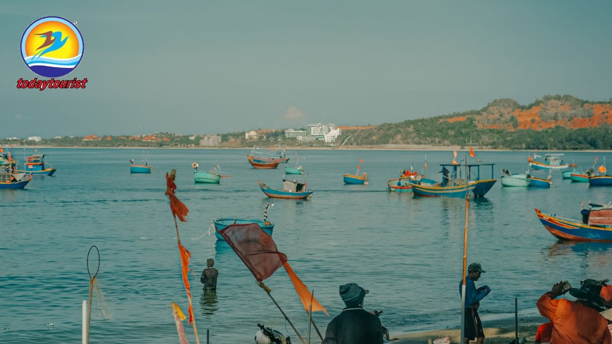 Vibrant fishing boats and locals by the seashore in Phan Thiet, Vietna